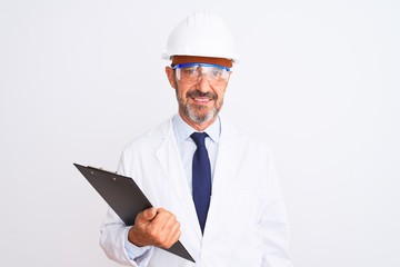 Senior engineer man wearing helmet glasses holding clipboard over isolated white background with a confident expression on smart face thinking serious