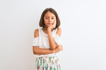Young beautiful child girl wearing casual dress standing over isolated white background thinking looking tired and bored with depression problems with crossed arms.