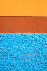 Abstract blue, brown and orange colors pattern on a wall.