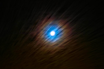 Halo effect - full moon behind cirrus clouds, sign of approaching weather change.