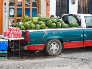 Pickup truck overflowing with watermelons for sale