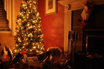 christmas tree and gifts near fireplace