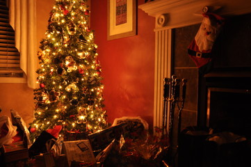 christmas tree and gifts near fireplace