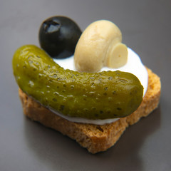 light snack breakfast of canned and pickled olives, cucumber, mushrooms with bread.  food and vegetables. diet and weight loss
