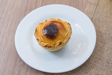 Delicious meat pie on white plate on the table