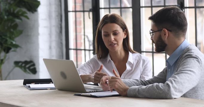Confident businesswoman professional manager talk to male client at meeting