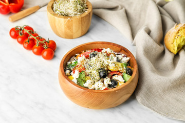 Bowl of tasty Greek salad on table