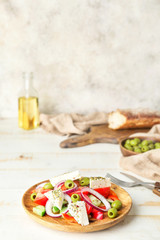Plate of tasty Greek salad on table