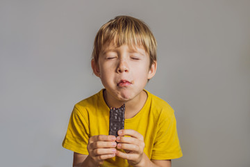 Close Up of Young Boy Eating A chocolate bar