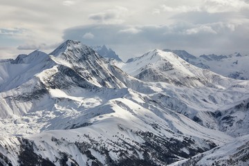 Fototapeta na wymiar Snowy mountains in winter weather high alpine landscape