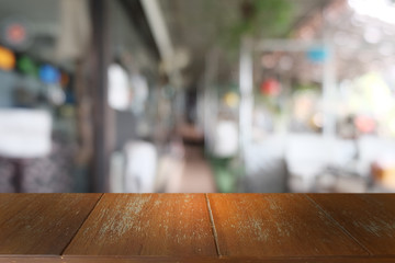 Empty dark wooden table in front of abstract blurred bokeh background of restaurant . can be used for display or montage your products.Mock up for space.