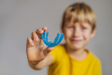 Six-year old boy shows myofunctional trainer. Helps equalize the growing teeth and correct bite,...