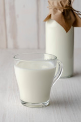 A glass bottle with kefir with bread rolls