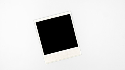 Retro empty photo frame. White plastic border isolated on white. Template photography, polaroid.