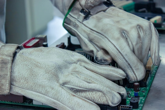 Worker Dismantling And Cleaning Of Print Circuit Board PCB For Its Recycling