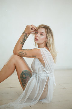 film photo of model with tattoos on white background