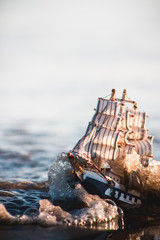 Toy boat sinking by the sea 2