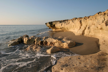 Fototapeta na wymiar Anastasia limestone outcropping in Blowing Rocks Preserve on Jupiter Island, Florida on clear cloudless morning at low tide.