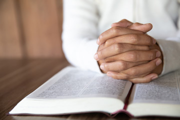 Naklejka premium A woman sitting and reading the bible And pray for God's blessing with faith in His power The idea of faith in the sacred power of God through prayer to Him Christianity, Jesus