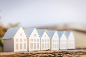 Paper house model on  wood , a symbol for construction , ecology, loan, mortgage, property or home.