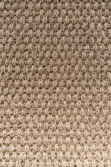 beige or straw colored wicker or seagrass, traditional weave rattan texture background.