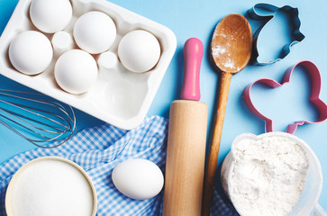 Easter baking. Ingredients and kitchen items for baking. Kitchen utensils, flour, eggs, sugar. Top view.