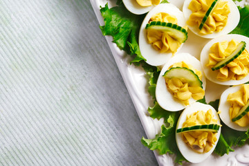 Deviled Eggs with Cucumber as an Appetizer, top view, copy space