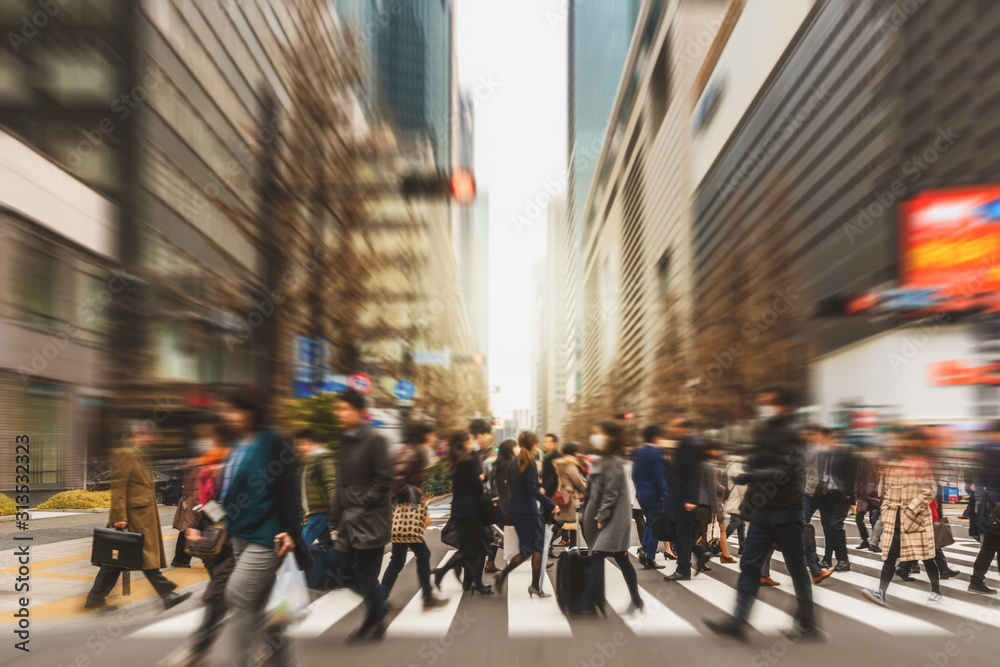 Wall mural blurred crowd of unrecognizable business people walking on zebra crossing in rush hour working day, 