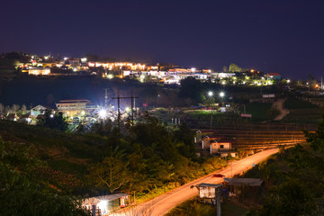Fototapeta premium High view beautiful nature landscape of colorful sky during the sunrise, see the lights of the road and city from the campsite at Phu Thap Berk viewpoint, Phetchabun Province, Thailand