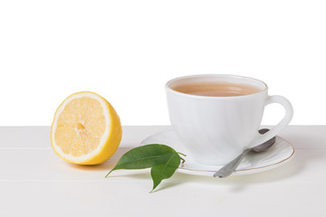 Fresh green tea with lemon in a white bowl on a white table isolated on a white background.