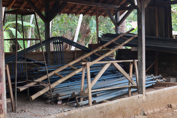 Pile of unassembled iron tent frame