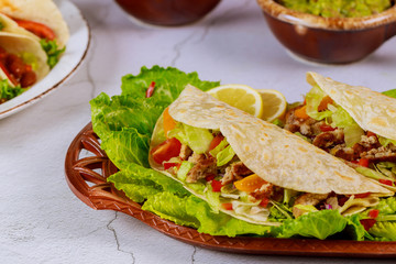 Mexican flour tortilla stuffed with lettuce, meat and cheese.