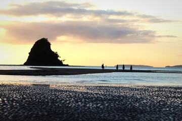 Fototapeta na wymiar A ride at dusk through the sea at Waiwera Beach. 