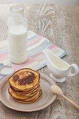 Breakfast pancakes with milk and maple syrup