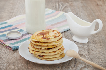 Breakfast pancakes with milk and maple syrup