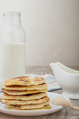 Breakfast pancakes with milk and maple syrup