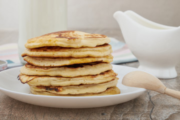 Breakfast pancakes with milk and maple syrup