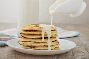 Breakfast pancakes with milk and maple syrup