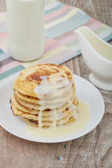 Breakfast pancakes with milk and maple syrup