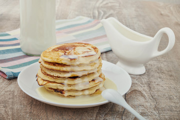 Breakfast pancakes with milk and maple syrup