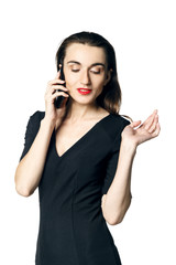 Business woman (fatal woman) in a black dress with red lipstick talking on the phone, isolated on a...