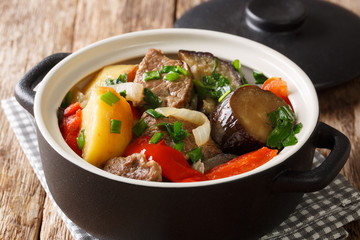 Tasty Georgian Chanakhi stew of meat and vegetables in a pot close-up on the table. horizontal