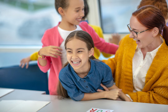 Laughing Teacher Having Fun With Her Schoolgirl