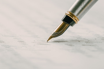 Fountain pen on an ancient handwritten letter. Old story. Retro style.