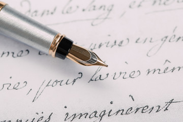Fountain pen on an ancient handwritten letter. Old story. Retro style.