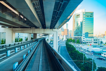 Naklejka premium Japan. Tokyo. Multilevel transport bridges in Tokyo. Transport system of the Japanese capital. Bridges and office building in Tokyo. Rail city transport. Transportation of passengers in the Japan.