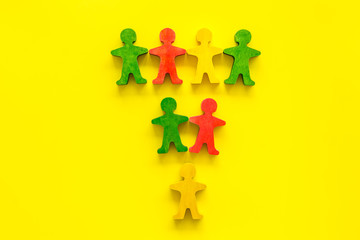 Team work, teambuilding concept. People cutouts on yellow background top-down copy space