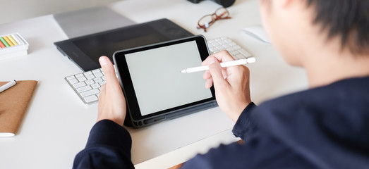 close up businessman hands multitasking man using tablet, laptop and cellphone connecting wifi.