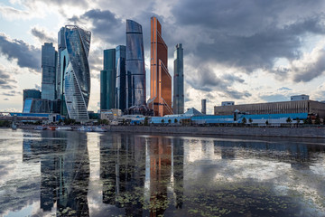 Fototapeta na wymiar Moscow. Russia. Skyscrapers near Moscow River. Skyscrapers overlooking the promenade. Real estate business in Moscow. Tour to Russia. Russian architecture. Panorama capital. Reflection in water