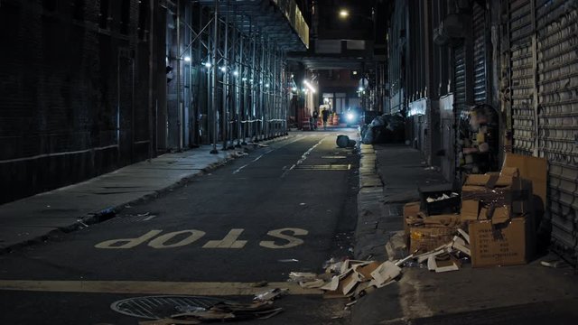 Urban New York City scenery, dark abandoned Downtown Manhattan narrow street by night 
